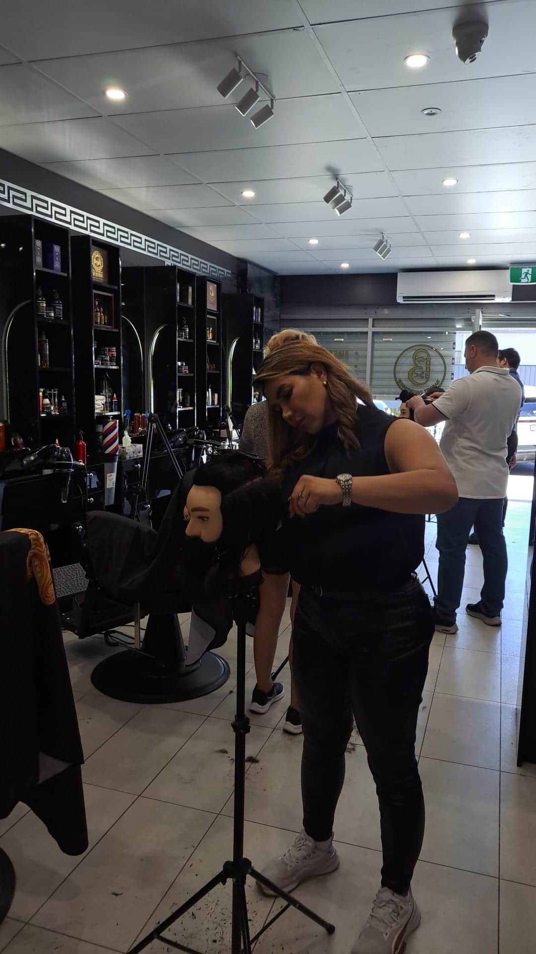 Close-up of a student executing a fade haircut