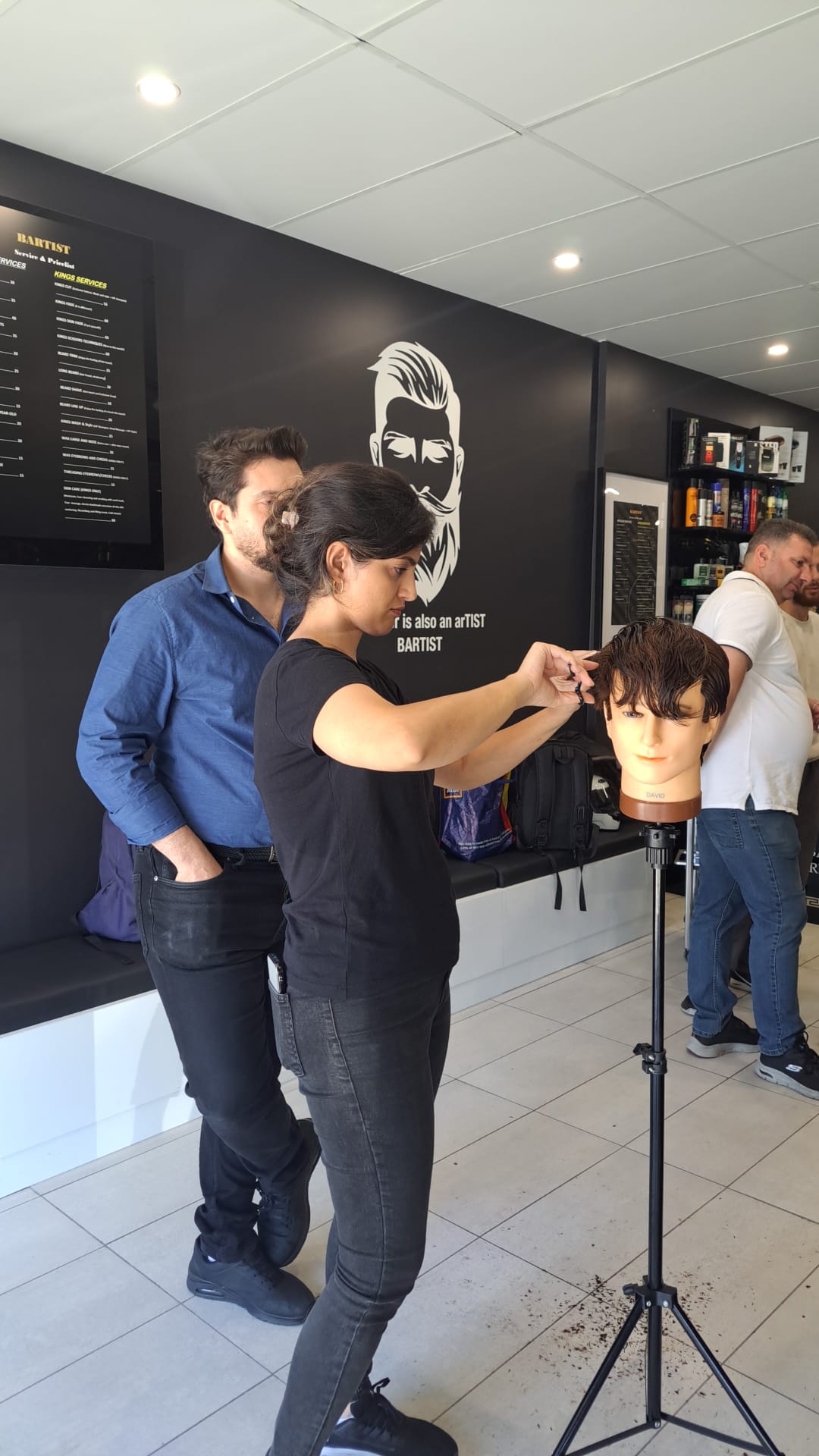 Harry.M providing one-on-one feedback to a student during a practical session
