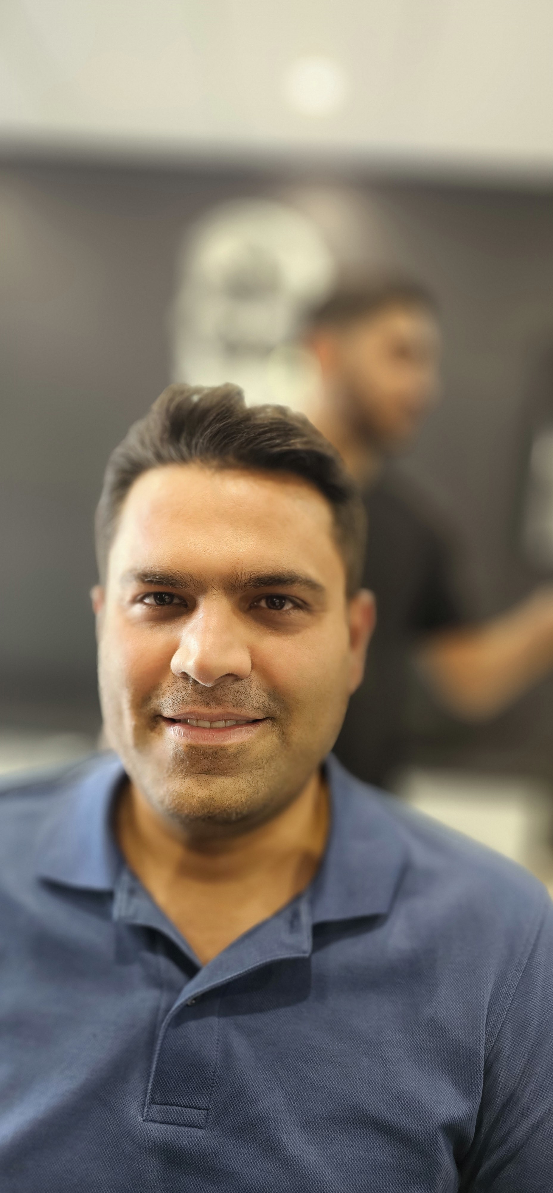 Harry.M demonstrating a haircut technique to students