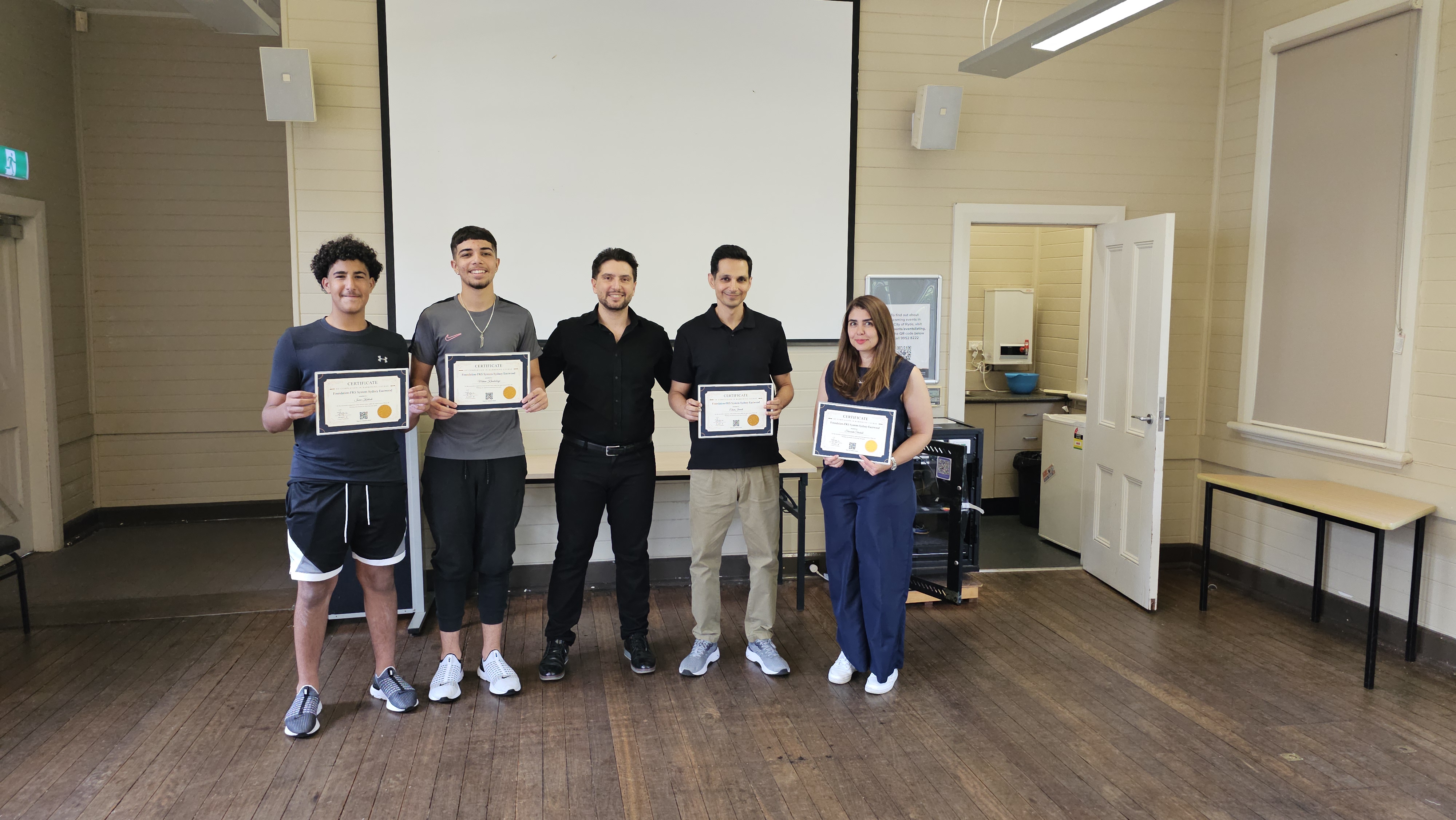 Harry.M providing one-on-one feedback to a student during a practical session