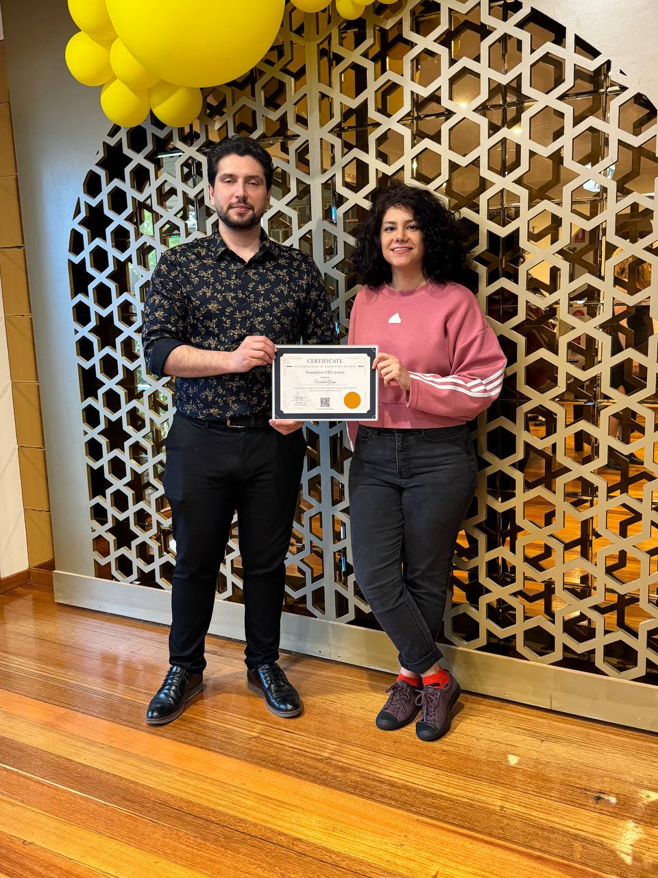 Harry.M providing one-on-one feedback to a student during a practical session