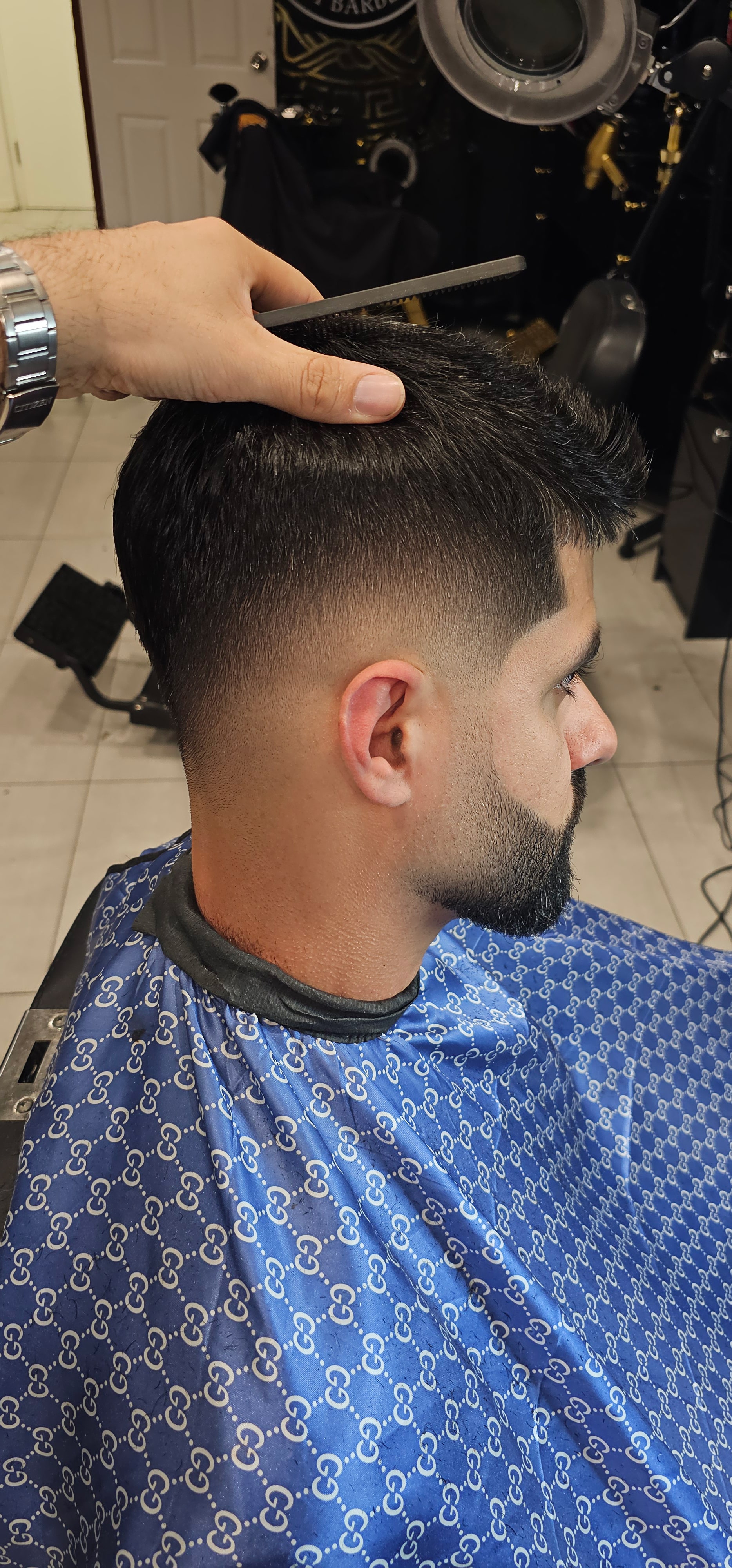 Harry.M demonstrating a haircut technique to students